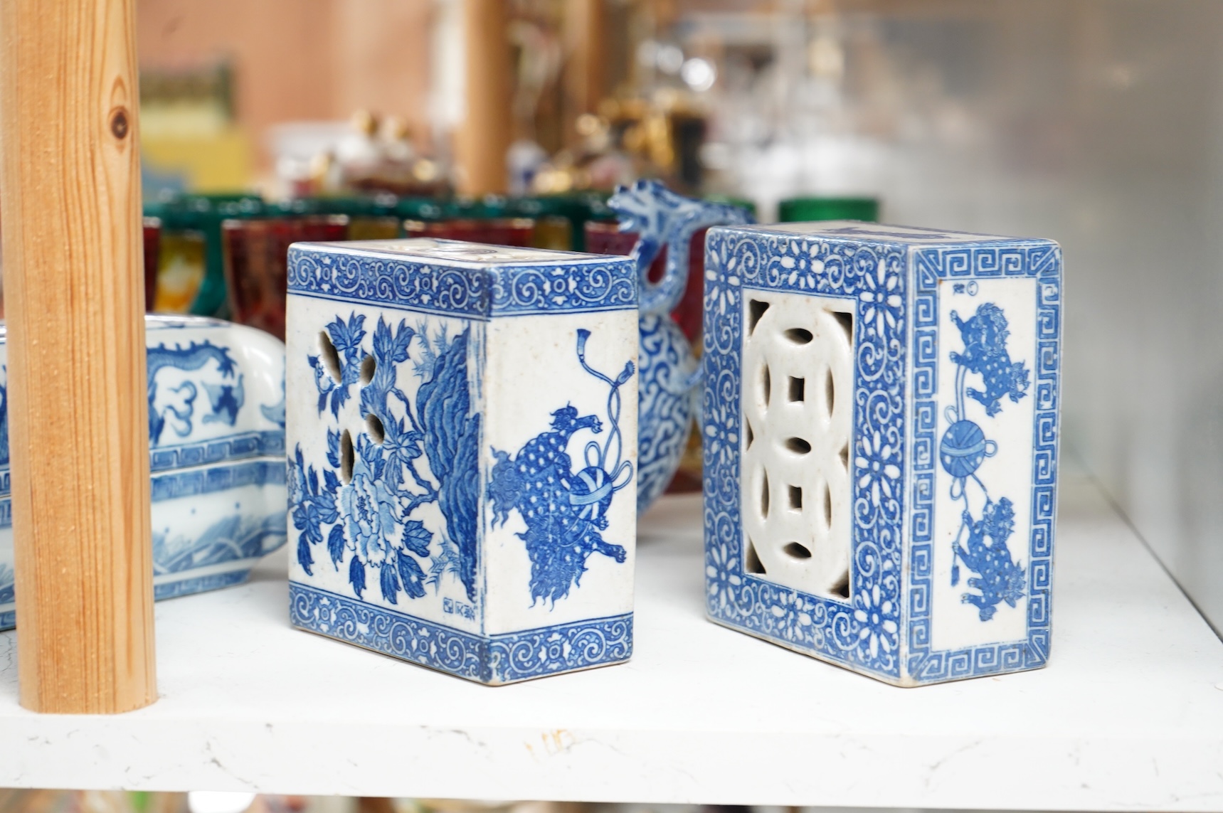 A group of Chinese blue and white comprising a dish and cover, two pillows, waterdropper and a teapot, largest 26cm wide